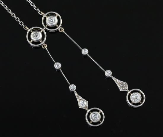 An early 20th century gold, silver and diamond set graduated double drop pendant, pendant 49mm.